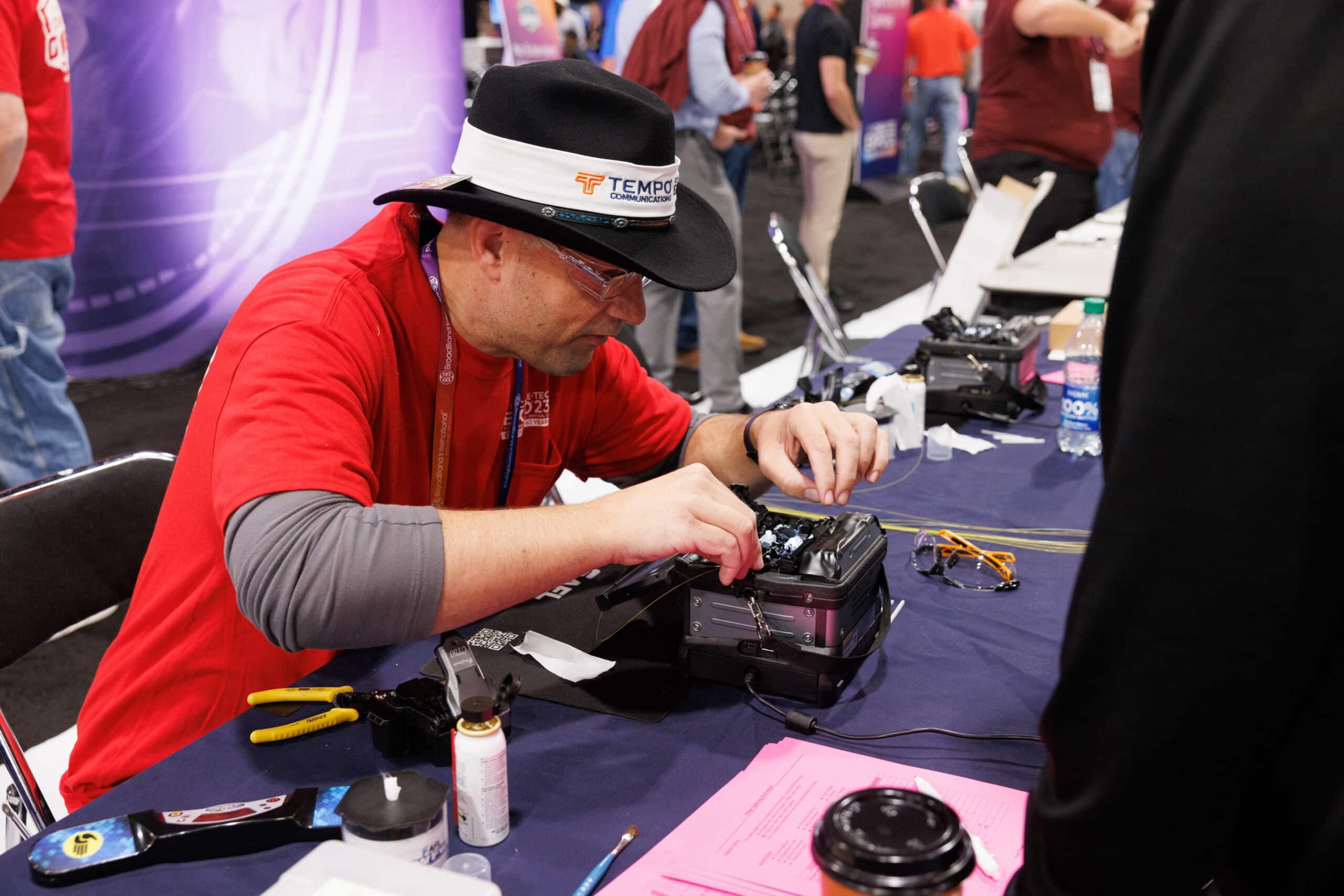 Person working on a piece of hardware at a conference