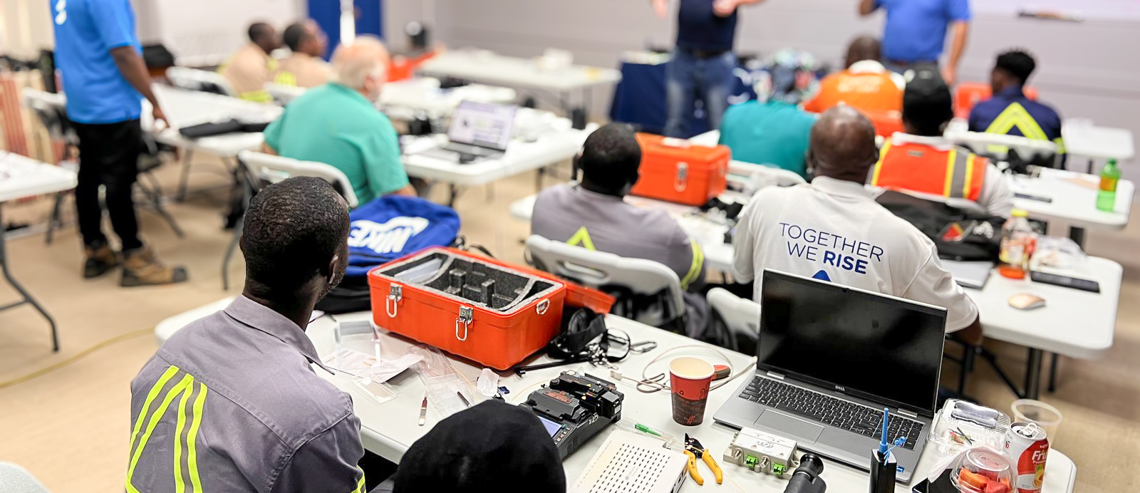 Group of people working on hardware in a classroom